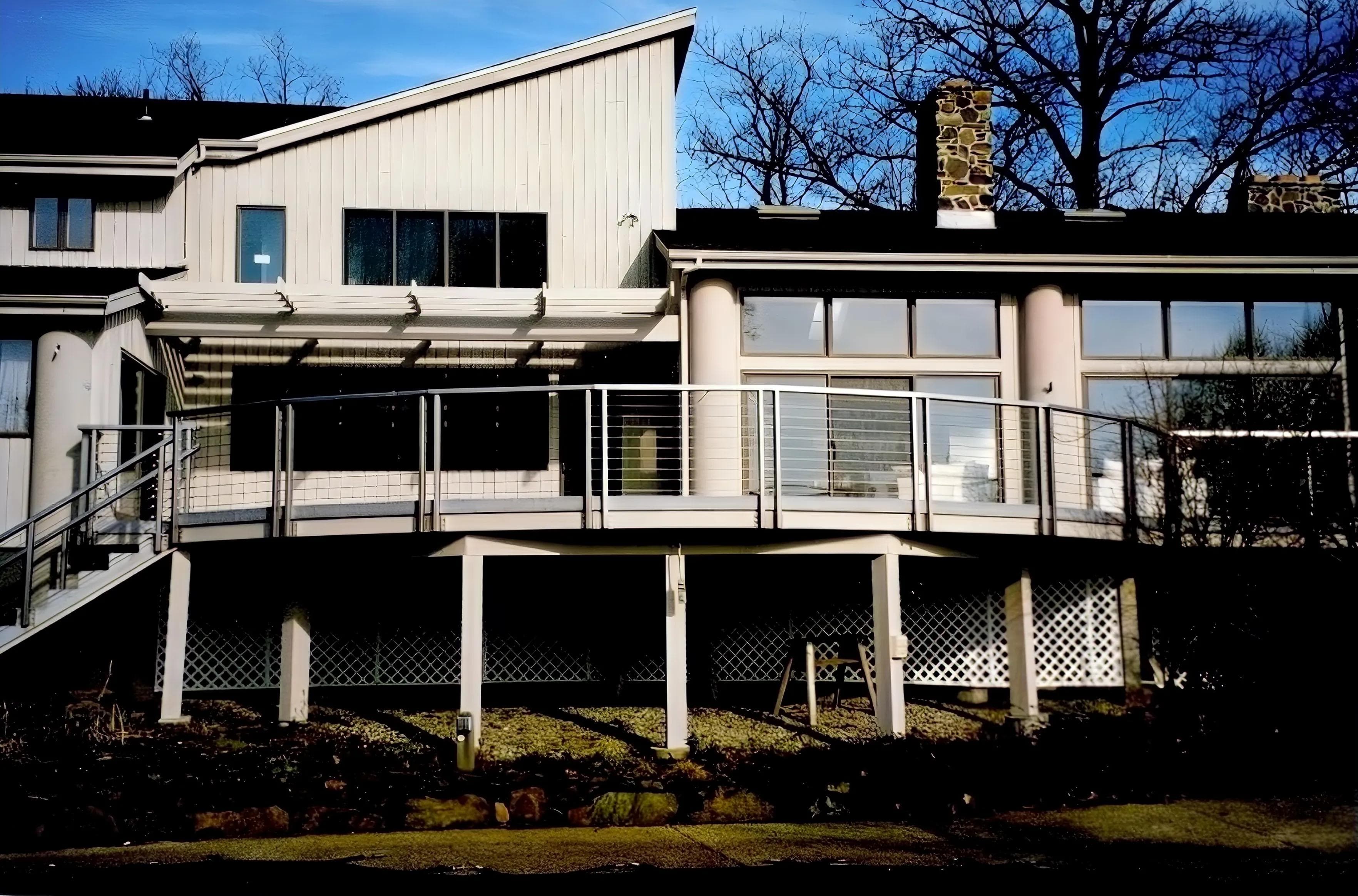 Custom curved exterior steel railing with cable infill at home in Ossining, NY.